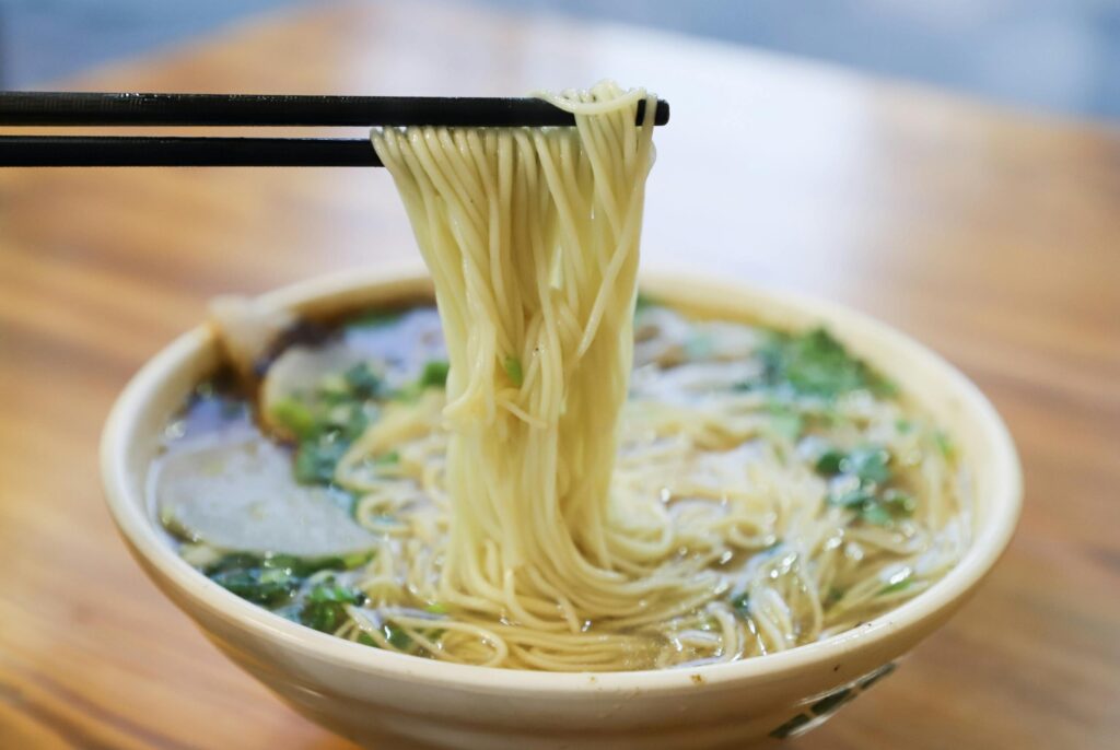 Using chopsticks at meal time Photo by Cats Coming Savor the mouthwatering taste of fresh ramen noodles lifted by chopsticks to make mealtime more fun for toddlers
