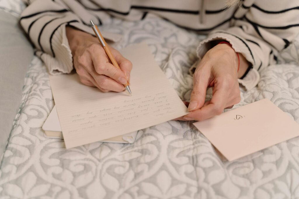 Woman writing letter Photo by cottonbro studio A woman writes a heartfelt letter with a pen on elegant stationery indoors.